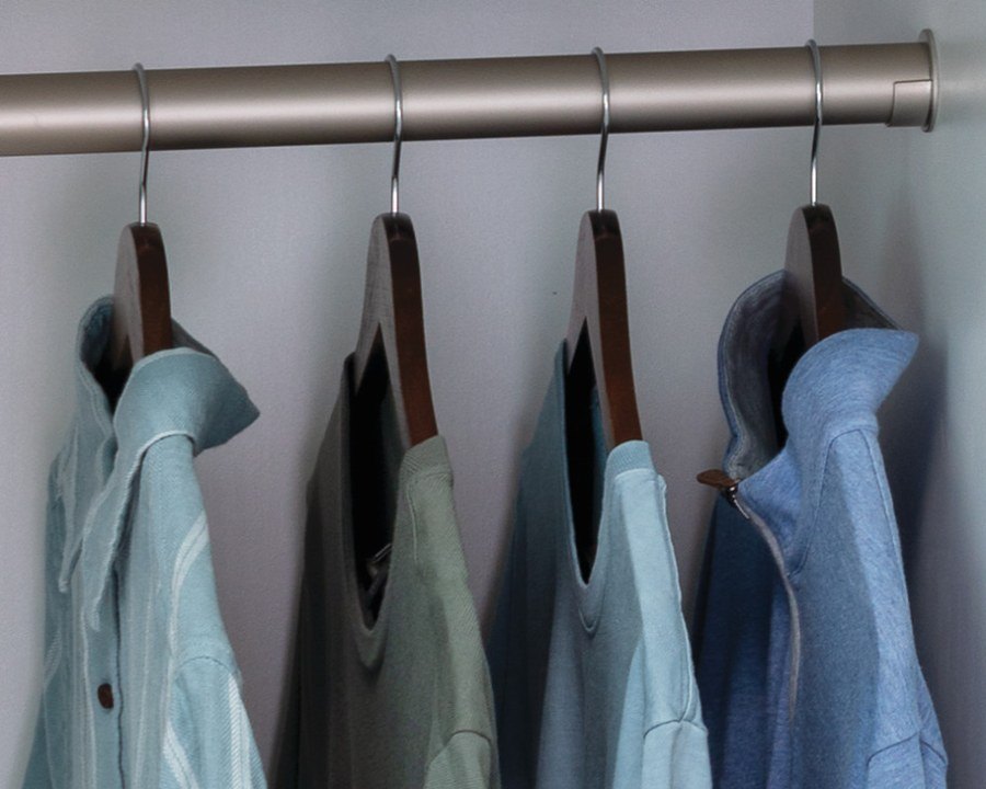 Closet rod with shirts on wooden hangers